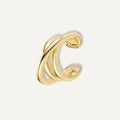 A sculptural statement for your ear stack. The Entwine Cuff features fluid, interlocking curves that create the look of layered metal—no piercing required. **Materials:** Gold-plated brass - Decollective -  - 