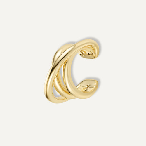 A sculptural statement for your ear stack. The Entwine Cuff features fluid, interlocking curves that create the look of layered metal—no piercing required. **Materials:** Gold-plated brass - Decollective -  - 